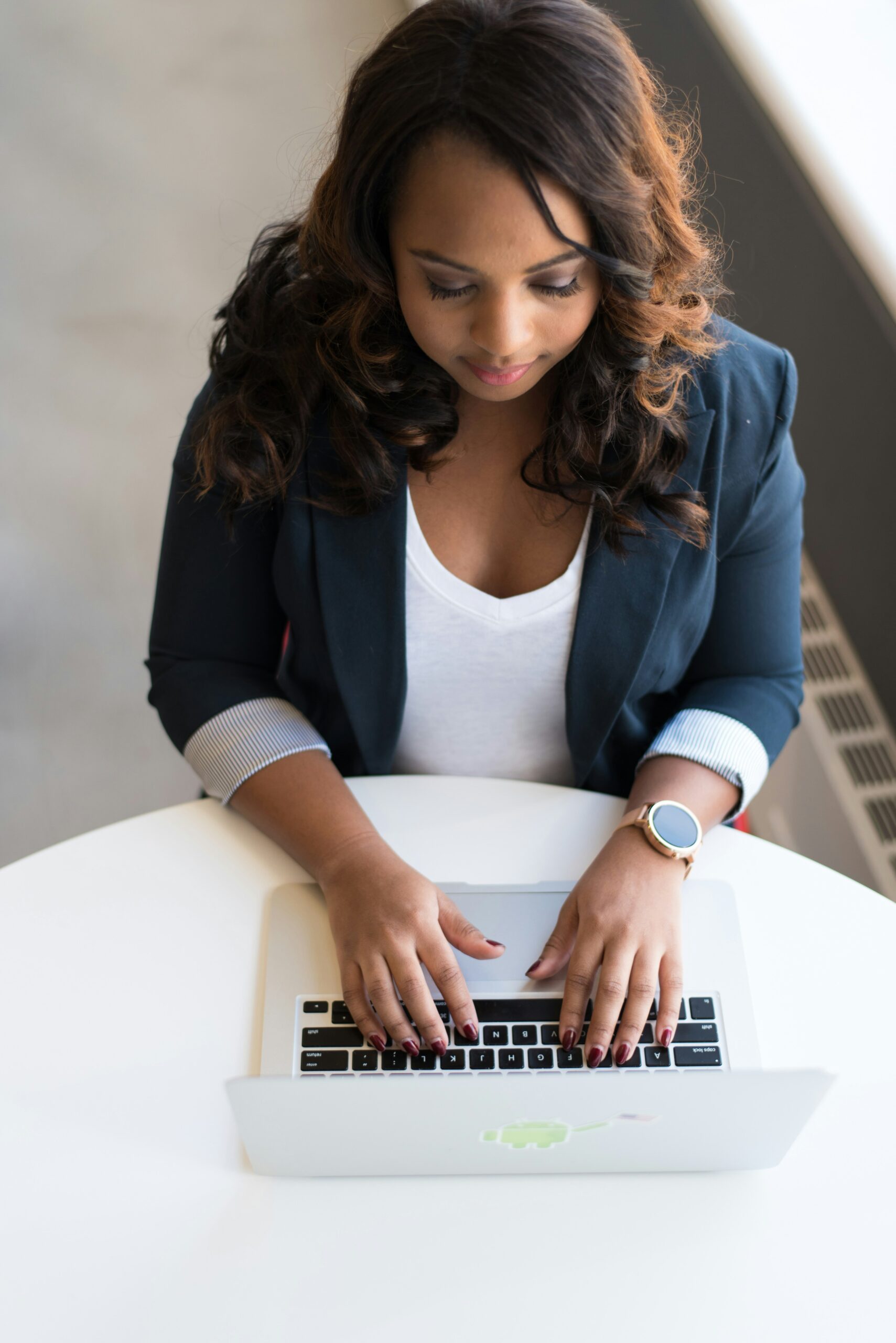 woman working on her computer. therapy can help high achievers move up in their professional lives