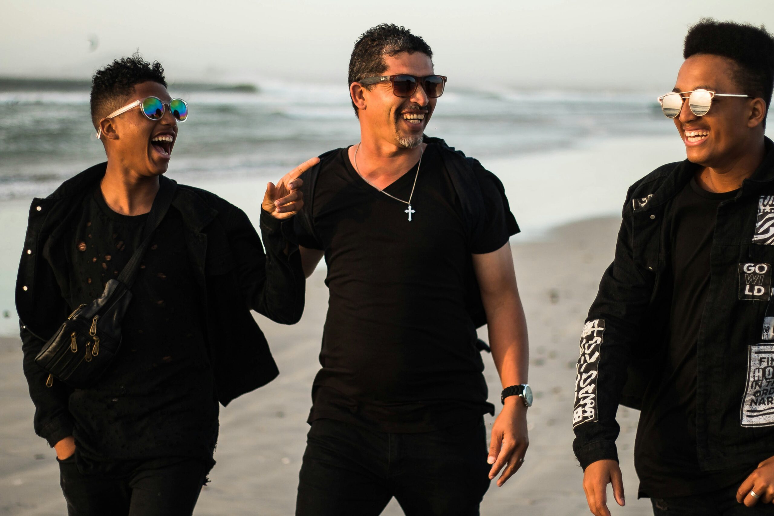 group of male friends on a beach supporting each other through disordered eating