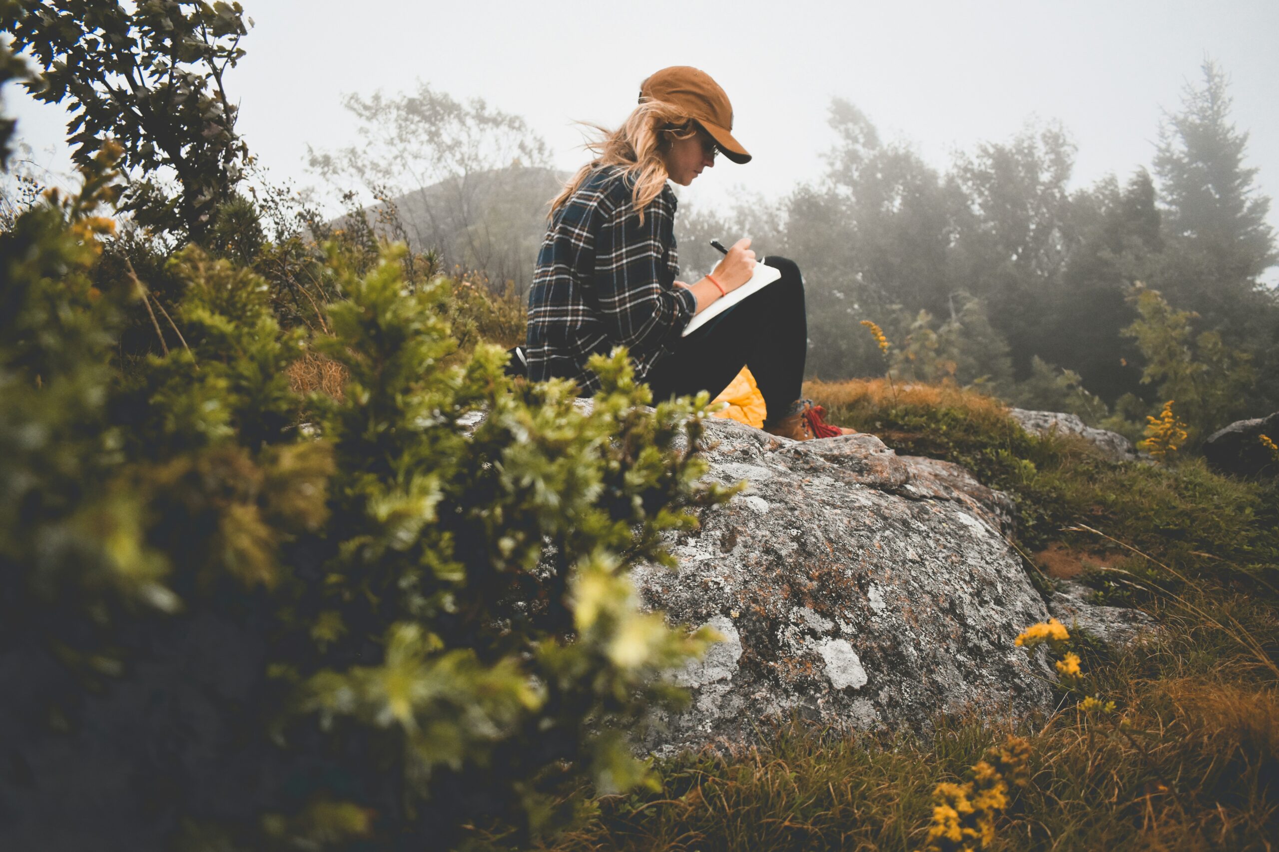 Brooklyn woman journaling in nature to help her find stress relief and mental clarity